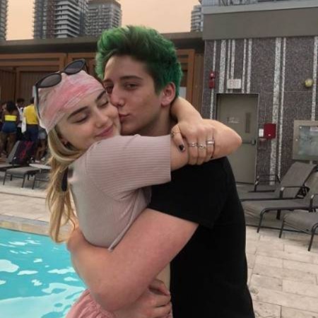 Milo Manheim kissing Meg Donnelly.